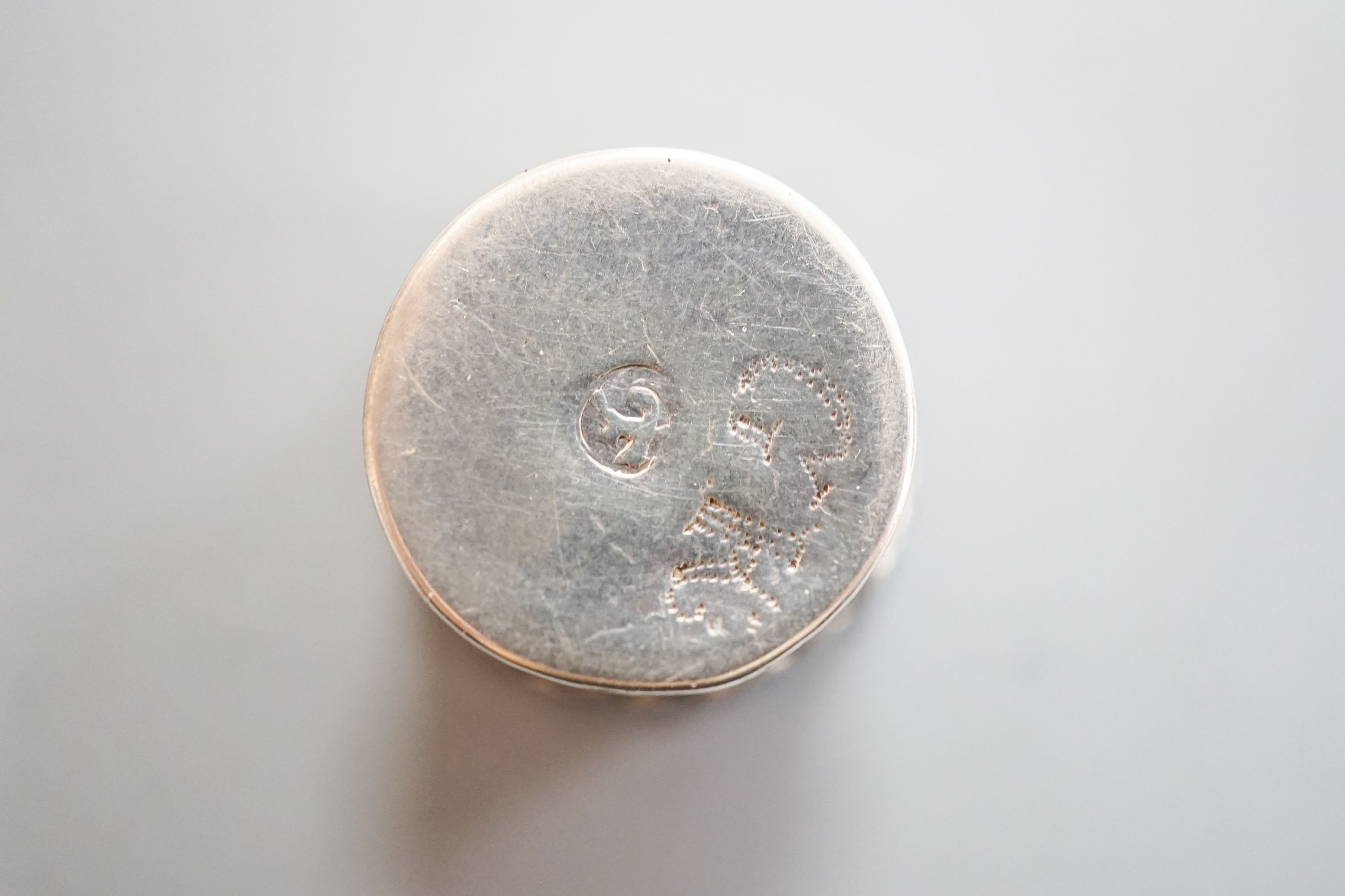 A mid 18th century German? small pill box, with engraved flower head decoration, 19mm.